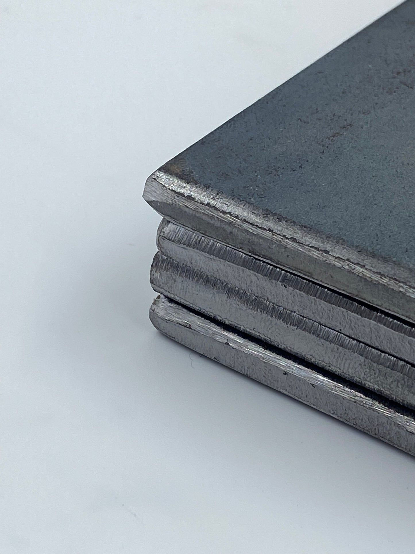 Close up view of the edge of several grade a 36 hot rolled carbon steel plates