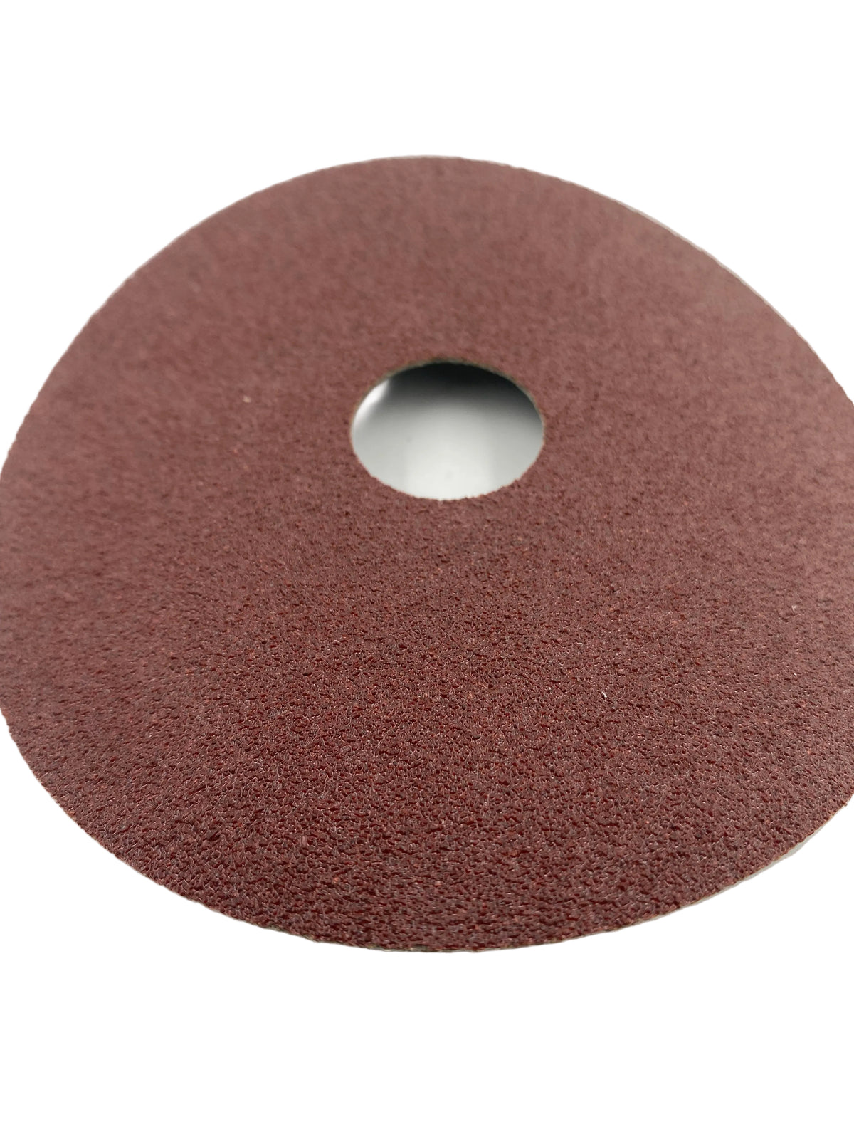 Close up of sanding disk on white background