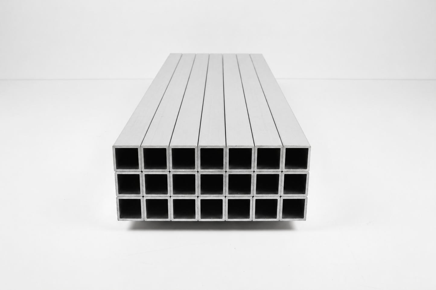 Stack of metal rectangular tubes on a white background