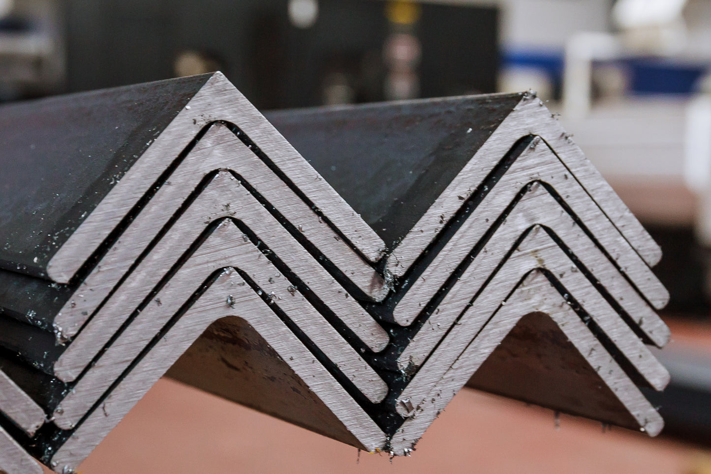 Stack of metal angle iron profiles on a blurred background